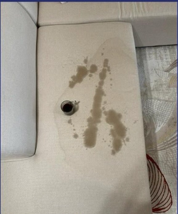 Sofa with a coffee stain before cleaning